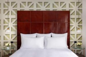 1 dormitorio con 1 cama grande con almohadas blancas en Maison Roma Piazza di Spagna UNA Esperienze en Roma