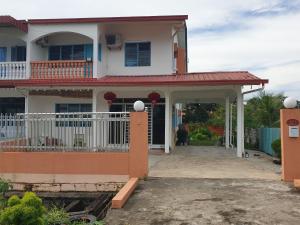 une maison blanche avec un toit rouge dans l'établissement Sibu Homestay Tekam, à Sibu