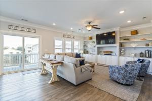 a living room with a couch and a table at Kind Of A Big Deal Brunswick Vacation Rentals Private home with pool and elevator in Holden Beach