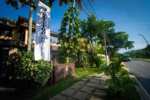 a sign for a hotel on the side of a street at Hotel Barra da Lagoa by Latitud Hoteles in Búzios