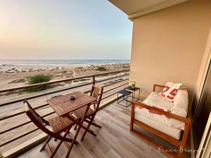 a balcony with a bed and a table and chairs at Ocean Breeze 9 in Sal Rei