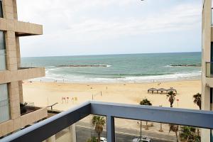 a view of the beach from the balcony of a building at Abratel Suites Hotel in Tel Aviv