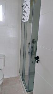Precioso apartamento en Gandía في Playa de Gandia: دش مع باب زجاجي في الحمام