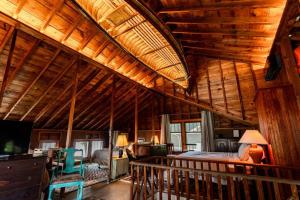 a large room with a bed and a wooden ceiling at The Doctor's Cottage - Vacation Back In-Time in Fremont