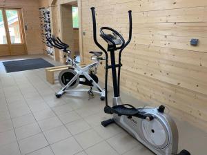 a room with a treadmill and a wooden wall at Chalet Bon Amour in Saint-Sorlin-dʼArves