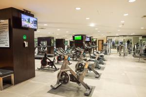 a gym with a lot of treadmills and machines at Eko Hotel Gardens in Lagos