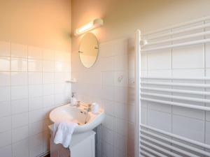 a white bathroom with a sink and a mirror at 1 bed in Brynteg 87362 in Llanwenog