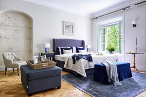 a bedroom with a bed and a blue chair at Zamek Janów Podlaski in Janów Podlaski