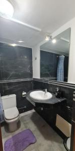 a bathroom with a sink and a toilet and a mirror at Dar sam in Tangier