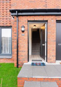 a brick building with a door and a staircase at Stylish House with Private parking in Glasgow