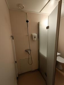 a shower stall in a bathroom with a shower at Apartment Nilsiä in Kuopio