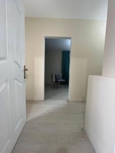 a hallway with a door and a chair in a room at Trendhouse in Ankara