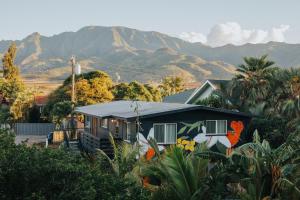 a house with a painting on it with mountains in the background at Akule Clubhouse in Waialua