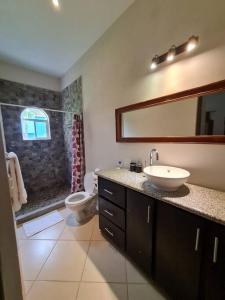 a bathroom with a sink and a toilet and a mirror at Golf and Ocean View Resort Home in San Diego
