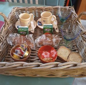 una cesta llena de pan, tazas y vasos en La Barabbata en Marta