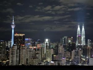 a view of a large city at night at Bunga Suite at Lucentia BBCC in Kuala Lumpur