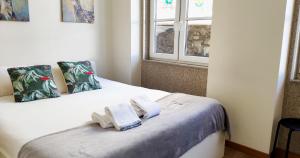 a bedroom with a bed with towels on it at Casa do Recanto - Private Suite in Porto