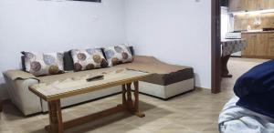 a living room with a couch and a table at Jordanovi Apartment in Kavadarci