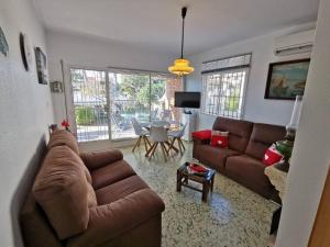 a living room with a couch and a table at 3 bedrooms house at Alcanar 100 m away from the beach with terrace and wifi in Alcanar