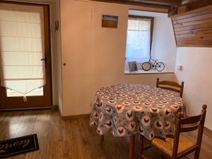 a dining room with a table and a window at Le Cantou in Castelnau-de-Mandailles +4 photos