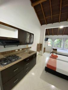 a kitchen with a stove and a bed in a room at 7 Express in Medellín