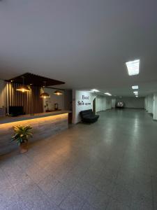 a large lobby with a hotel sign on the wall at 7 Express in Medellín