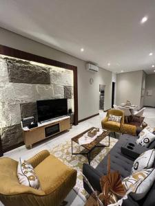 a large living room with couches and a fireplace at Elite Apartment 3 in Riyadh
