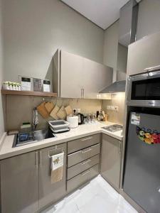 a small kitchen with a sink and a refrigerator at Elite Apartment 3 in Riyadh