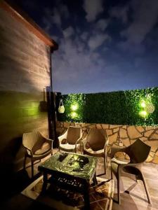 a patio with a table and chairs and a stone wall at Elite Apartment 3 in Riyadh