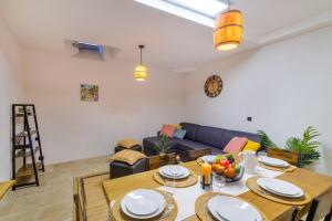 a living room with a table and a couch at Charmant Appartement - Saint Paul de Vence Village in Saint-Paul-de-Vence