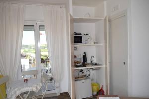 een kamer met een keuken met een magnetron en een raam bij One bedroom property with wifi at Canosa di Puglia in Canosa di Puglia