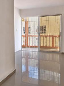 an empty room with a glass door and a window at Bright Charming Apartment in San Pedro de Macorís