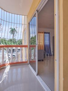 a balcony with a view of a building at Bright Charming Apartment in San Pedro de Macorís