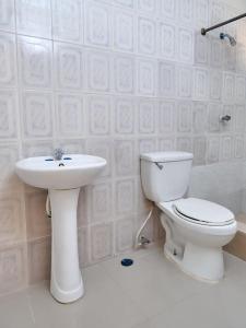 a bathroom with a toilet and a sink at Bright Charming Apartment in San Pedro de Macorís