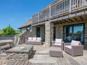 a patio with chairs and a table and a bench at 3 Bed in Worth Matravers DC063 in Worth Matravers