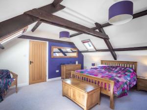 a bedroom with a king sized bed and blue walls at 4 Bed in Beadnell 83469 in Swinhoe