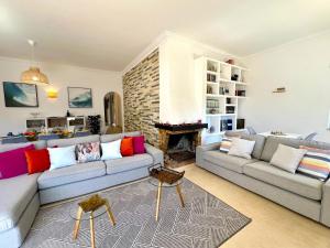 a living room with two couches and a fireplace at Vilamoura Brightness Villa With Pool by Homing in Vilamoura