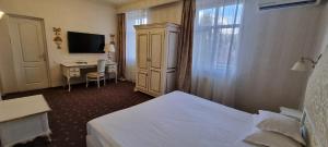 Postel nebo postele na pokoji v ubytování Topaz Boutique