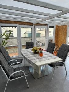 a white table and chairs on a patio at Kuscheliges Einfamilienhaus in Lingenfeld