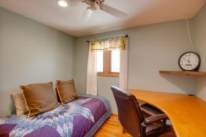 a bedroom with a bed and a clock on the wall at Charming Illinois Retreat with Hot Tub, Deck and Grill in Schaumburg