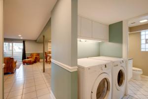 a laundry room with a washer and dryer at Charming Illinois Retreat with Hot Tub, Deck and Grill in Schaumburg