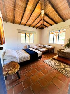 a bedroom with two beds and a brick floor at Disfruta nuestro bello paraíso ! in La Ceja