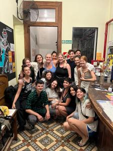 a group of people posing for a picture in a room at Parla Hostel in Buenos Aires