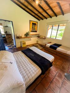 a bedroom with two beds in a room at Disfruta nuestro bello paraíso ! in La Ceja