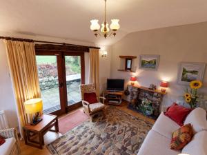 a living room with a couch and a fireplace at The Granary Ruthwaite in Uldale