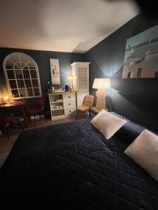 a bedroom with a large bed and a desk at B&B De Koog Texel in De Koog
