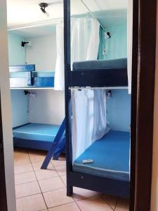 a bunk bed with blue bunk beds in a room at Santa Catarina Hostel in Florianópolis