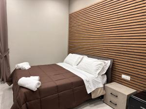 a bedroom with a bed with a wooden headboard at DIMORA DEL PLEBISCITO B&b in Naples