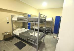 a room with three bunk beds in a room at Rooms DP Setúbal in Setúbal