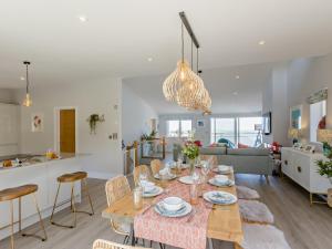 a dining room and living room with a table and chairs at 4 Bed in Appledore 92041 in Appledore